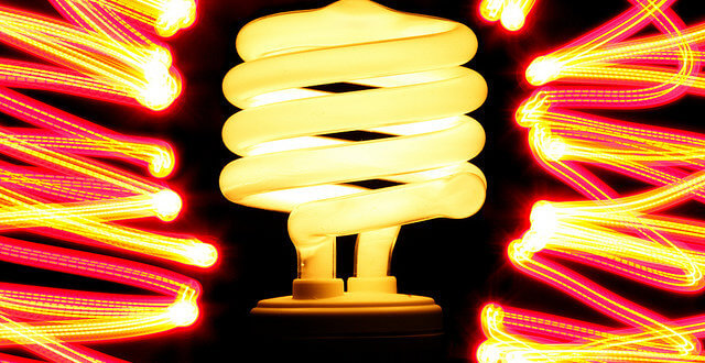 Photo of CFL light bulb with red and yellow swirls of light surrounding it
