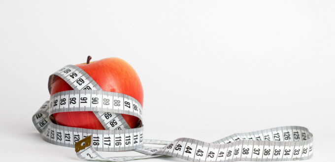 Red Apple wrapped with Tape Measure
